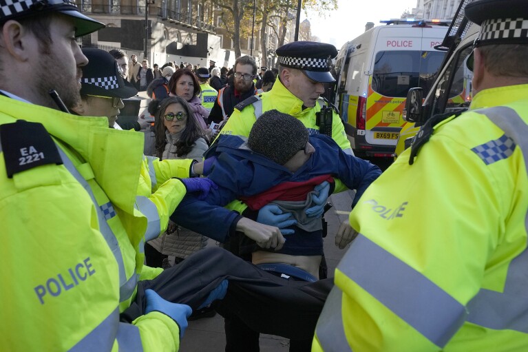 Police arrest protesters of the climate campaigners group Just Stop Oil outside Downing Street in London, Thursday, Nov. 23, 2023.(AP Photo/Frank Augstein)